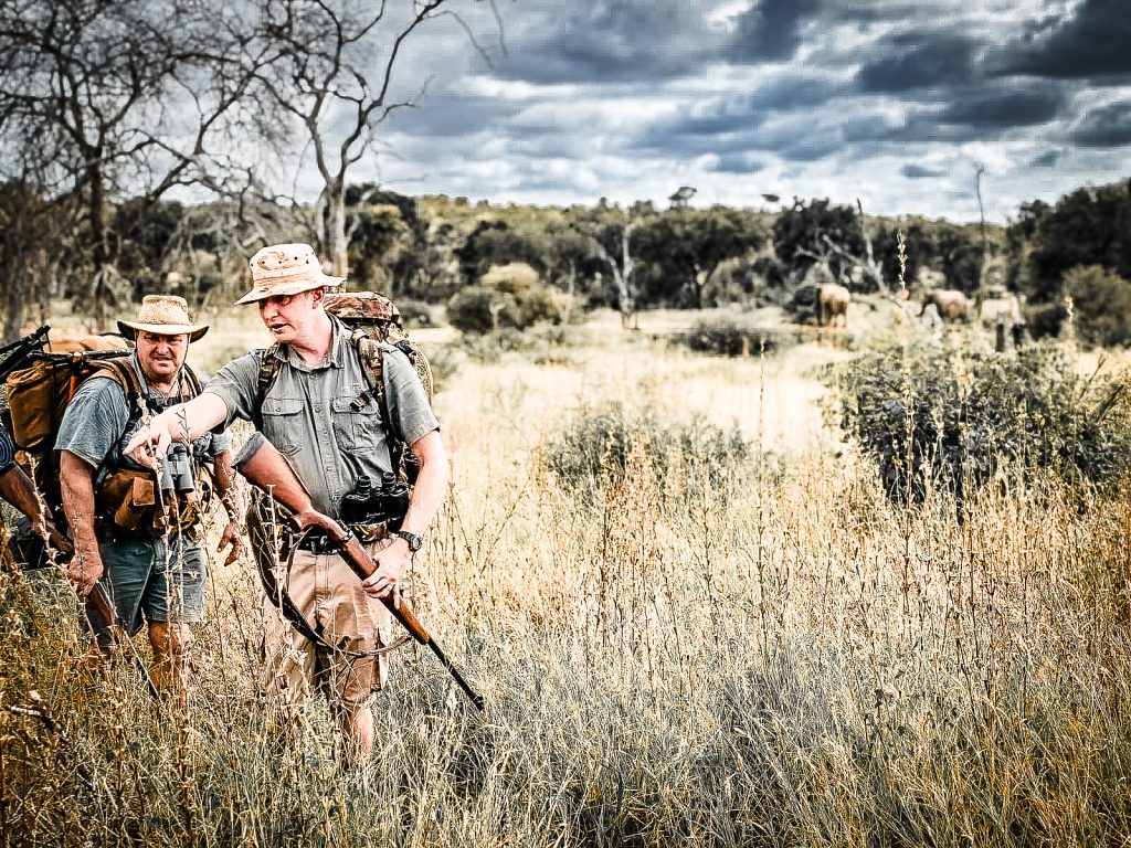 Manukuza Wilderness Trails guide walking with rifle